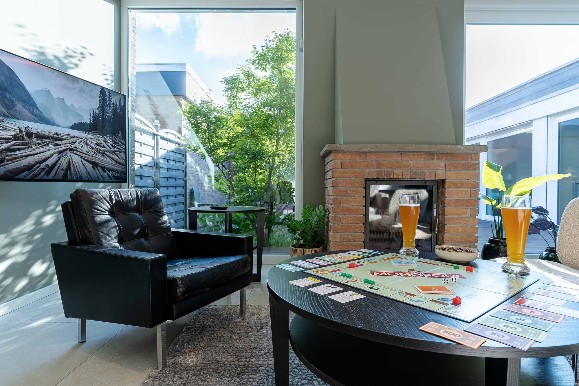 Leather armchair and coffee table set with a board game and two drinks, a cosy corner of the living room